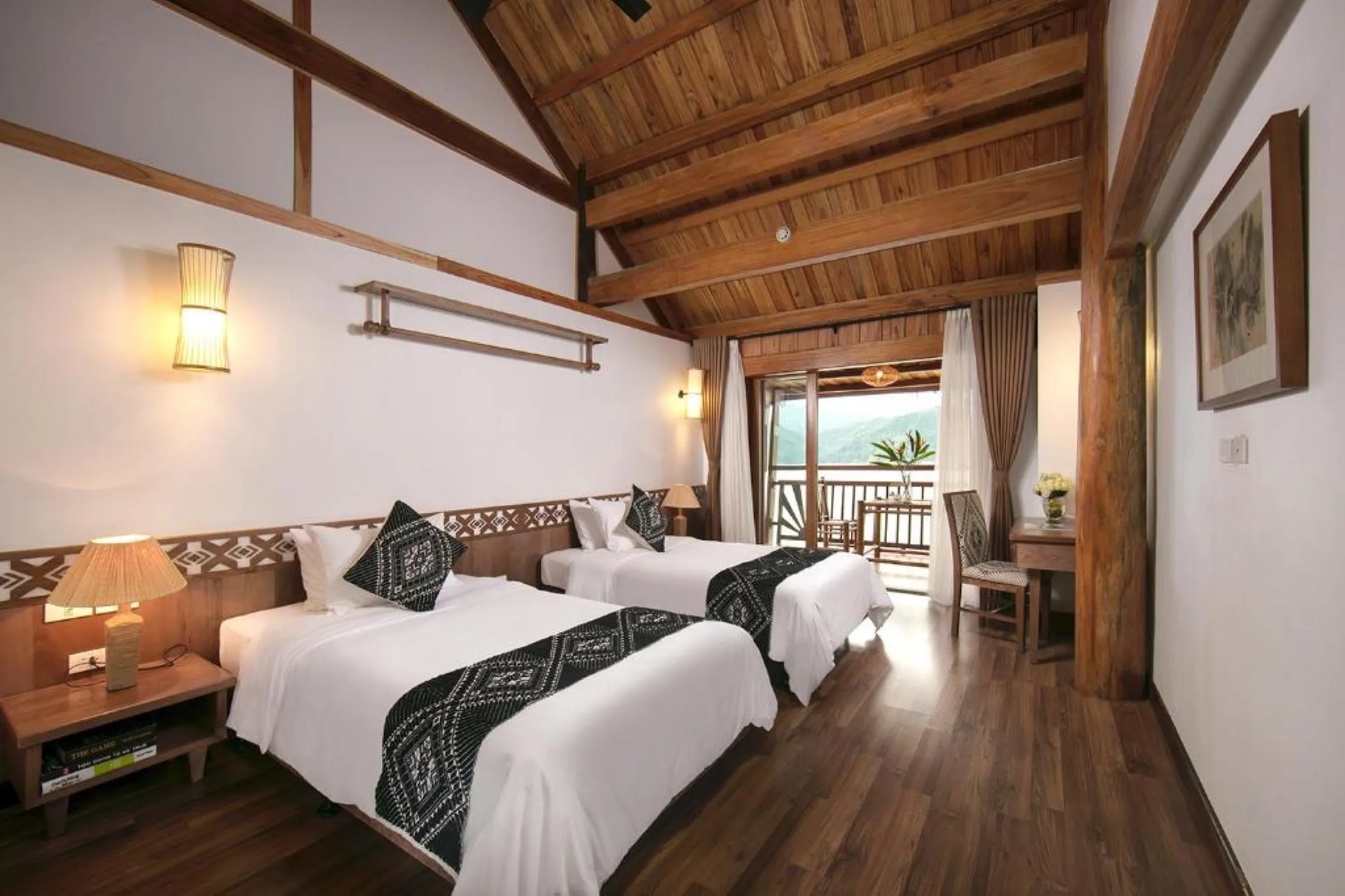 A twin room with wooden ceilings and ethnic textiles at the Mai Chau Hideaway.
